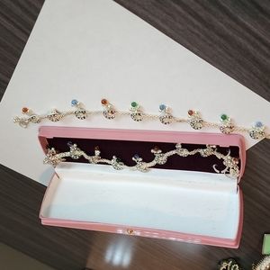 Two silver and multicolored anklets